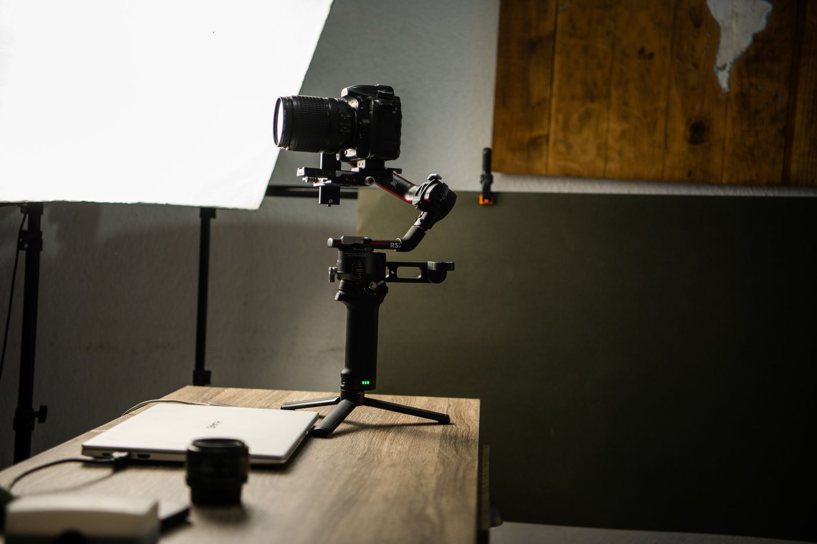 7 simple video editing tips for beginners showing a laptop with video editing timeline and smartphone setup